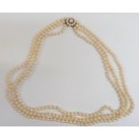 A three strand cultured pearl necklace with a 9ct gold clasp