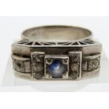 Art Deco white metal ring set with a round cut cornflower blue sapphire and old cut diamonds by