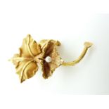 A 9k gold brooch in the form of a lily set with a pearl to the centre, 11.9g (5.7 x 3.2cm)