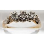 An 18ct gold ring set with three diamonds in a platinum setting, 2.7g, size L