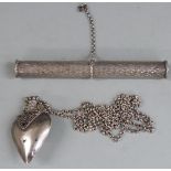 A heart shaped scent bottle on chain and a scroll holder with engraved decoration, length 14cm,