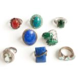 Eight silver rings marked 925 set with malachite, azurite, lapis lazuli and aquamarine