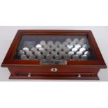A collection of UK shillings in glass topped collector's case around 50 in all including some pre-