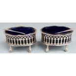 Pair of Victorian hallmarked silver salts with pierced decoration and blue glass liners and rasied