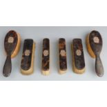 Tortoiseshell six piece dressing table set with yellow metal mounts formed as initials