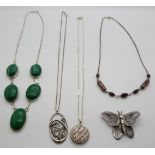 A silver necklace set with malachite cabochons, three silver necklaces and a silver butterfly
