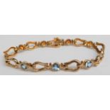 A 14ct gold bracelet set with round cut blue topaz,12.3g