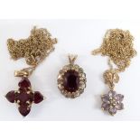 A 9ct gold pendant set with garnets, 9ct gold pendant set with topaz and 9ct gold pendant set with