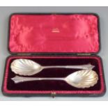 Victorian cased pair of hallmarked silver serving spoons with shell bowls, London 1895 maker