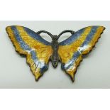A silver brooch set with blue and yellow enamel in the form of a butterfly, 5 x 2.5cm
