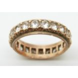 A rose gold eternity ring set with white sapphires, 4g, size O