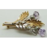 9ct gold bi-coloured brooch set with purple paste and seed pearls in the form of a thistle and fern,