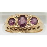 An 18ct gold ring set with three garnets, Birmingham 1919, in original box, 2.6g, size O