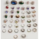 A collection of silver rings set with tiger's eye, quartz, amethyst, garnet, paste, peridot etc