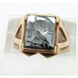 A 9ct gold ring set with a carved hematite intaglio, 5.8g, size P