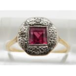 An 18ct gold ring set with a square cut ruby and diamonds in a platinum setting, 2.5g, size N