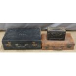 Two vintage suitcases and a military ammunition box