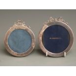 Two matching Edward VII circular hallmarked silver photograph frames with bow decoration to tops,