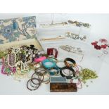 A collection of costume jewellery to include brooches, beads, hat pins, paste jewellery, silver