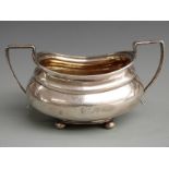 Georgian hallmarked silver twin handled sugar bowl with gilt wash interior, raised on four ball