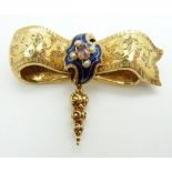 Victorian gold bow brooch with engraved scrolling detail set with a central foiled quartz surrounded