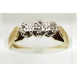 An 18ct gold ring set with three diamonds in a platinum setting, 3.1g, size M