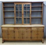 Early 20thC Cotswold School Arts & Crafts studded oak dresser with central two door glazed cabinet