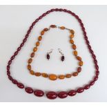 Two amber necklaces, one cherry amber of 47 graduated oval beads the largest 25x17.5mm, 46g with