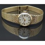 Waltham 9ct gold ladies wristwatch with black hands, two-tone baton markers, silver dial and 17