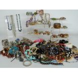 A collection of costume jewellery including white metal brooch set with enamel, silver bangle,