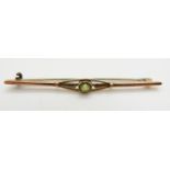 A 9ct gold brooch set with a round cut peridot