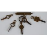 Five pocket watch keys including one stamped Gloucester Street, Stroud