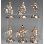 Set of six white metal novelty menu holders formed as people carrying various baskets and