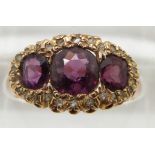 Victorian 15ct gold ring, Birmingham 1899, set with cushion cut garnets surrounded by diamonds,