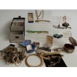 A collection of costume jewellery including brooches, garnet necklace, Avon, etc