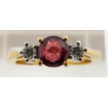 An 18ct gold ring set with a round cut natural ruby of approximately 0.7ct, origin Sri Lanka, and