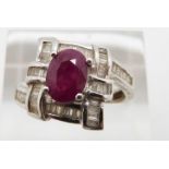 A 14k white gold ring set with a ruby and diamonds, total diamond weight approximately 0.32ct, 4.9g,