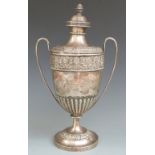 Victorian hallmarked silver pedestal twin handled trophy cup with repoussé decorated borders,