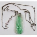 Art Deco white metal necklace set with a carved jadeite plaque, 3.5cm long