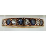 A 9ct gold eternity ring set with alternating sapphires and white sapphires, 4.1g, size N