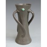Tudric Pewter Arts and Crafts waisted vase with wrythen handles and turquoise colored cabochons,