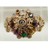 A 18k gold ring set with diamonds, a pink sapphire, emerald, tiger's eye, garnet, citrine, topaz