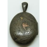 Victorian white metal locket with engraved bamboo and applied gold bird and insect decoration