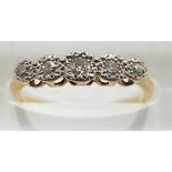 An 18ct gold ring set with five diamonds in a platinum setting, 1.7g, size L