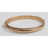9ct gold bangle with rope twist border, 10.62g, 6.1 x 5.4cm