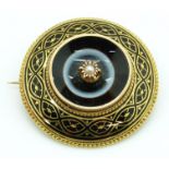 Victorian brooch set with black enamel and banded agate with a central pearl, within a rope twist