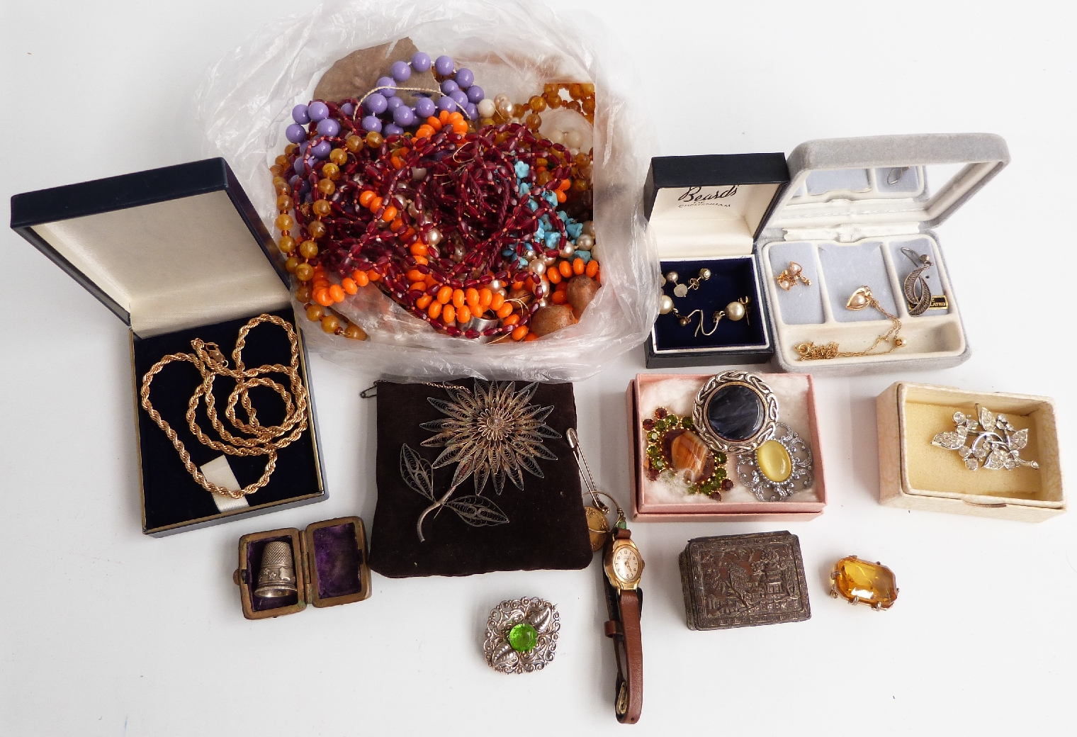 A collection of costume jewellery including filigree brooch, beads, thimble in case, brooches etc