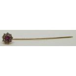 A 9ct gold stick pin set with a ruby and cubic zirconia