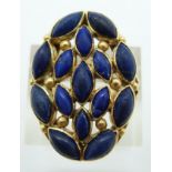 Eastern yellow metal ring set with marquise cut lapis lazuli cabochons, tested as 15ct/16ct gold,