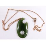 A nephrite jade pendant on 9ct gold chain, 4cm long